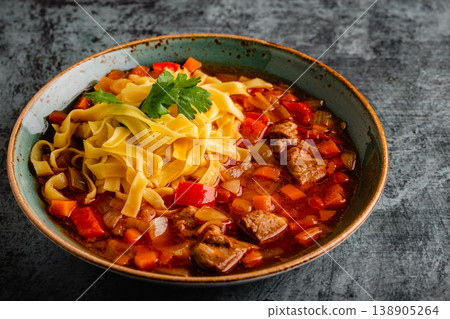 Lagman soup with lamb, homemade noodles and vegetables. 138905264