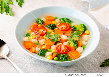 Soup with mini dumplings and vegetables. 138905295