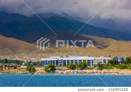 Lively beach scene with sunbathers and swimmers in Kyrgyzstan 138905380