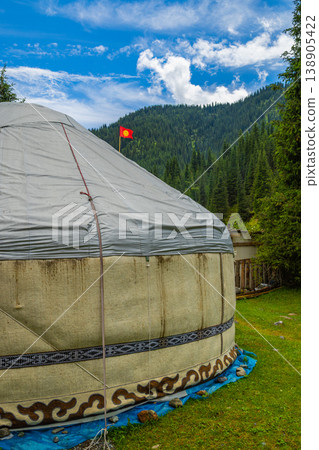 Yurt with flag of Kyrgyzstan in serene mountainous landscape Yurt with flag of Kyrgyzstan in serene mountainous landscape 138905422