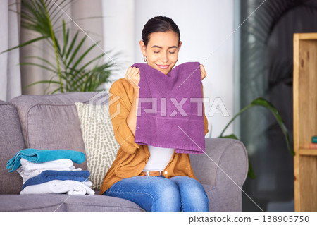 Woman, cleaning and smell towel, fresh and clean laundry in home with happy smile. Content female relax and smelling the scent of washing, happiness and fragrance of material and fabric in home Woman, cleaning and smell towel, fresh and clean laundry in home with happy smile. Content female relax and smelling the scent of washing, happiness and fragrance of material and fabric in home 138905750