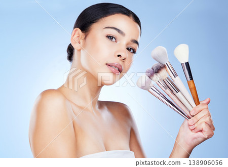Makeup, beauty brushes and portrait of woman on blue background for cosmetics, powder and foundation. Cosmetology, salon aesthetic and face of girl with tools for application, wellness and skin glow 138906056