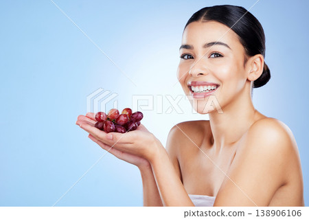 Grape, woman and portrait for face skincare, cosmetics or food product on studio background. Happy young model, grapeseed fruit and oil of nutrition, vegan diet or detox wellness of natural aesthetic Grape, woman and portrait for face skincare, cosmetics or food product on studio background. Happy young model, grapeseed fruit and oil of nutrition, vegan diet or detox wellness of natural aesthetic 138906106