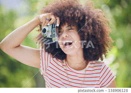 Nature, afro and black woman with photography camera taking happy picture memory with retro style. African hipster girl with smile in park using vintage photographer equipment to capture moment. Nature, afro and black woman with photography camera taking happy picture memory with retro style. African hipster girl with smile in park using vintage photographer equipment to capture moment. 138906128
