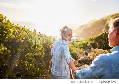 Love, holding hands and nature, senior couple walking with picnic blanket for romance and valentines day. Green mountain path, old man and woman on walk or hike for romantic valentine date at sunset. Love, holding hands and nature, senior couple walking with picnic blanket for romance and valentines day. Green mountain path, old man and woman on walk or hike for romantic valentine date at sunset. 138906129
