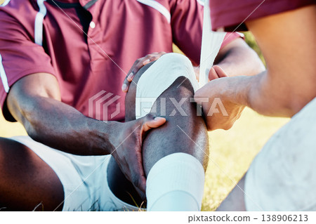 Knee pain, sport injury and bandage on athlete outdoor, rugby and fitness with black man, team and first aid. Medical emergency, wound and sports accident, training and exercise with help and medic Knee pain, sport injury and bandage on athlete outdoor, rugby and fitness with black man, team and first aid. Medical emergency, wound and sports accident, training and exercise with help and medic 138906213