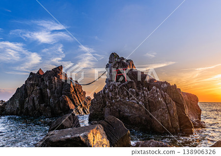 A golden sunset viewed over the rocks of the male and female dragons. 138906326