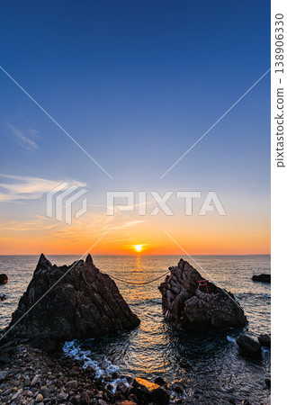 A beautiful sunset sinking into the calm sea of Tanegashima 138906330