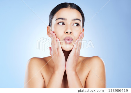 Woman, beauty and skincare with pout, lip filler and aesthetic cosmetics on blue background. Female model, lips and kissing face for plastic surgery, facial treatment and dermatology in studio Woman, beauty and skincare with pout, lip filler and aesthetic cosmetics on blue background. Female model, lips and kissing face for plastic surgery, facial treatment and dermatology in studio 138906419