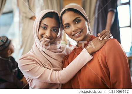 Sisters, hug and Muslim women with hijab in house, religious and social gathering for festive event. Islamic, portrait and people with smile for Ramadan, embrace and traditional clothes for culture Sisters, hug and Muslim women with hijab in house, religious and social gathering for festive event. Islamic, portrait and people with smile for Ramadan, embrace and traditional clothes for culture 138906422