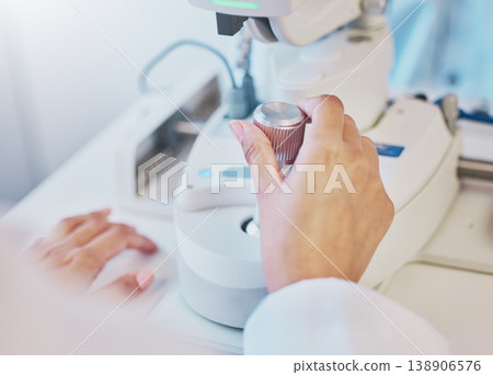 Ophthalmology, test and hand of a doctor on a machine for a consultation, vision check and monitor lens. Medicine, healthcare and optician moving a handle on equipment for analysis of eyes and retina Ophthalmology, test and hand of a doctor on a machine for a consultation, vision check and monitor lens. Medicine, healthcare and optician moving a handle on equipment for analysis of eyes and retina 138906576