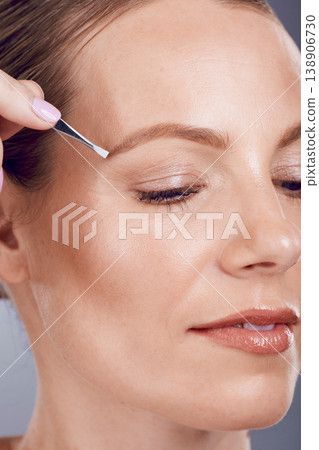 Eyebrow tweezers, face beauty and woman in studio for skincare wellness, aesthetic spa and facial. Female model, brows and hair removal for cosmetics, growth maintenance and epilation tools for shine Eyebrow tweezers, face beauty and woman in studio for skincare wellness, aesthetic spa and facial. Female model, brows and hair removal for cosmetics, growth maintenance and epilation tools for shine 138906730
