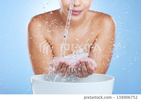 Woman, hands and water splash by basin for skincare hygiene or hydration against blue studio background. Hand of female in liquid drops washing for clean wellness or natural sustainability by sink Woman, hands and water splash by basin for skincare hygiene or hydration against blue studio background. Hand of female in liquid drops washing for clean wellness or natural sustainability by sink 138906752