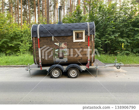A mobile bathhouse on a trailer parked near a forest road A mobile bathhouse on a trailer parked near a forest road 138906790