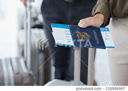 Passport, travel and airport with the hand of a passenger holding documents while waiting for a flight. Immigration, identity and boarding pass with a person holding a ticket leaving for a holiday Passport, travel and airport with the hand of a passenger holding documents while waiting for a flight. Immigration, identity and boarding pass with a person holding a ticket leaving for a holiday 138906907