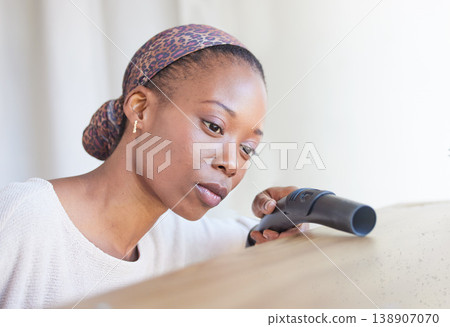 Cleaning, vacuum and hygiene with a black woman doing housework or chores alone in a home. Living room, furniture and housekeeping with a female cleaner working in a house on domestic duties Cleaning, vacuum and hygiene with a black woman doing housework or chores alone in a home. Living room, furniture and housekeeping with a female cleaner working in a house on domestic duties 138907070