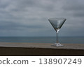 a martini glass stands against the background of the black sea in Batumi 138907249
