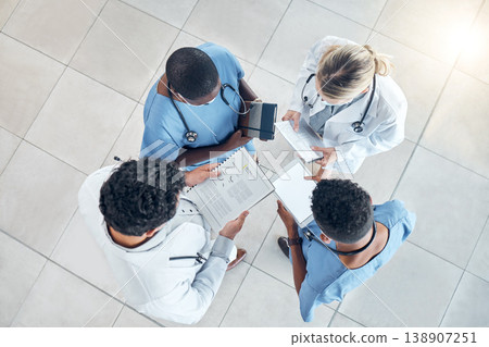 Doctor documents, nurse data and hospital information of a healthcare medical team in a clinic. Teamwork and collaboration above view of nursing and health staff with paper and digital results 138907251