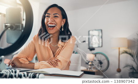Social media and business influencer streaming live tutorial, laughing and talking to her online followers. Guiding subscribers on finance, investment, banking and accounting while enjoying her blog 138907342