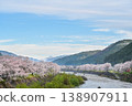 A photograph of cherry blossoms and snow-covered mountains in the early morning mist [Gujō City, Gifu Prefecture] 138907911