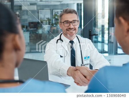 Handshake, nurse and doctor shaking hands after success in a medical surgery at a trustworthy hospital. Partnership, collaboration and physician welcomes a healthcare worker to the team in a meeting Handshake, nurse and doctor shaking hands after success in a medical surgery at a trustworthy hospital. Partnership, collaboration and physician welcomes a healthcare worker to the team in a meeting 138908040