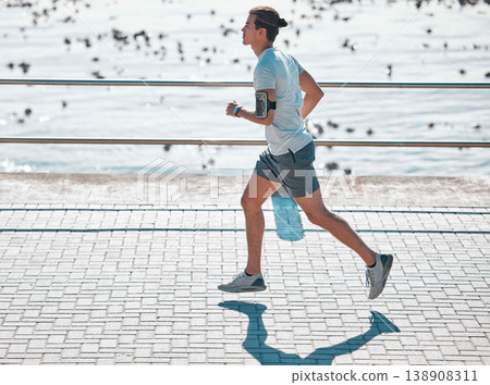 Cardio, fitness and man running on the promenade for training, health and workout by the beach. Exercise, sports and runner by the sea in the morning for jogging and outdoor sports for motivation Cardio, fitness and man running on the promenade for training, health and workout by the beach. Exercise, sports and runner by the sea in the morning for jogging and outdoor sports for motivation 138908311