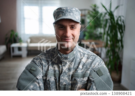 Portrait of smiling american veteran soldier standing at home Portrait of smiling american veteran soldier standing at home 138908421