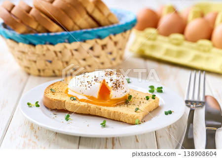 Poached egg with runny yolk and microgreens on a toasted bread for healthy breakfast . Healthy breakfast food concept. Poached egg with runny yolk and microgreens on a toasted bread for healthy breakfast . Healthy breakfast food concept. 138908604