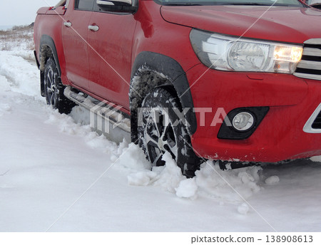 Wheel of the car stuck in the deep snow detailed Wheel of the car stuck in the deep snow detailed 138908613