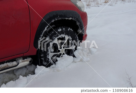 Front wheel of the car got got stuck in the deep snow Front wheel of the car got got stuck in the deep snow 138908616