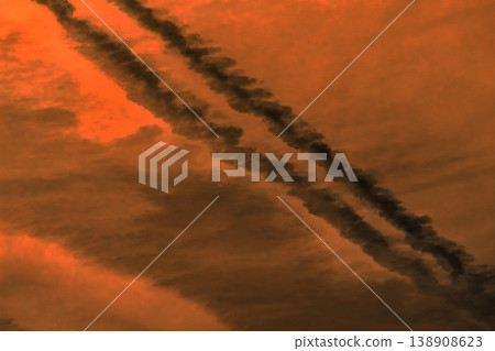 Traces airplane air trail jet line stripe sunset orange sky background Traces airplane air trail jet line stripe sunset orange sky background 138908623