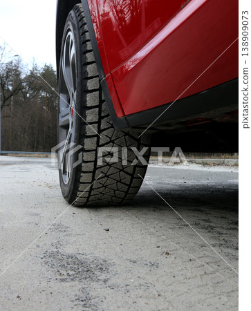 Sand on the tire tread of rear wheel of the car on a road side Sand on the tire tread of rear wheel of the car on a road side 138909073