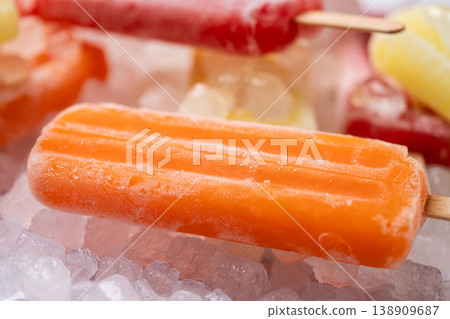 Colorful fruit popsicles on crushed ice Colorful fruit popsicles on crushed ice 138909687