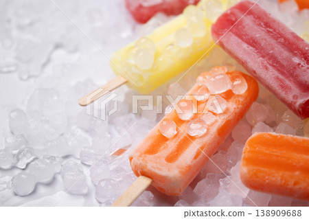 Colorful fruit popsicles on crushed ice Colorful fruit popsicles on crushed ice 138909688