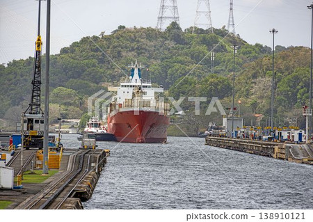 Cargo ship entering Panama Canal lock with tugboats Cargo ship entering Panama Canal lock with tugboats 138910121