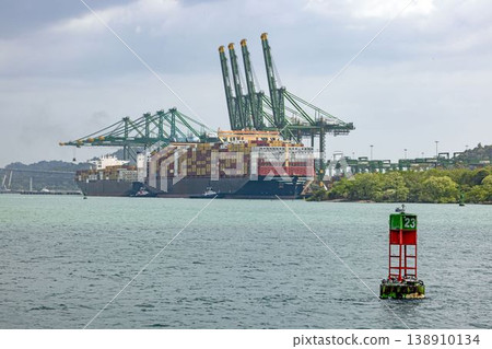 Container ship at Panama Canal port with cranes and buoy Container ship at Panama Canal port with cranes and buoy 138910134