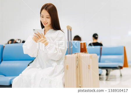 A woman relaxing in the airport lobby before departure. (Photo courtesy of Kansai International Airport (KIX)) A woman relaxing in the airport lobby before departure. (Photo courtesy of Kansai International Airport (KIX)) 138910417