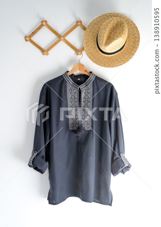 Ukrainian clothes embroidered man shirt. Blue gray and black threads background. Vyshyvanka is a symbol of Ukraine. Embroidery cross stitching. National Ukrainian stitch. Traditional clothing symbol 138910595