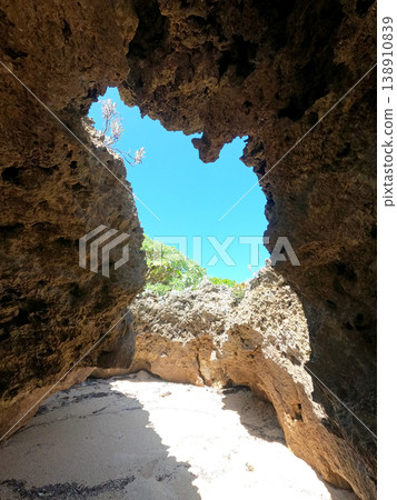 A rocky cave on the coast of Tsuken Island, surrounded by sandy beaches and blue sea, Uruma City, Okinawa Prefecture. 138910839
