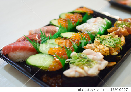 A platter of nigiri sushi featuring salmon roe and tuna. A platter of nigiri sushi featuring salmon roe and tuna. 138910907