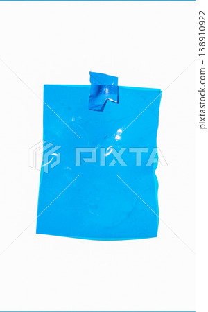 Blank blue crumpled plastic film sheet attached to a white background with tape, providing copy space Blank blue crumpled plastic film sheet attached to a white background with tape, providing copy space 138910922