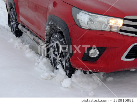 Front wheel of the truck in deep snow on the country road 138910991