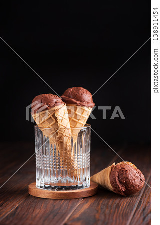 Chocolate Ice Cream Cones on Dark Wooden Background Chocolate Ice Cream Cones on Dark Wooden Background 138911454