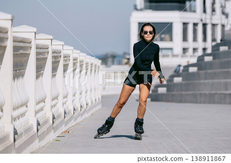 Roller skater riding along modern promenade, active lifestyle Roller skater riding along modern promenade, active lifestyle 138911867
