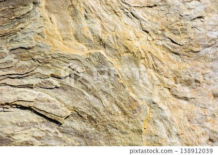 grunge texture of yellowish gray stone. natural rock background shot outside. aged matte patterns of sandstone with subtle cracks grunge texture of yellowish gray stone. natural rock background shot outside. aged matte patterns of sandstone with subtle cracks 138912039