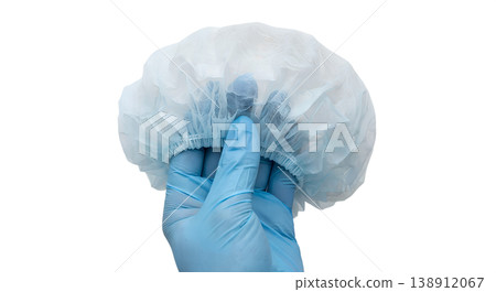 Hand holding disposable blue medical bouffant hair cap, isolated on transparent background, representing hygiene, food service, and healthcare settings Hand holding disposable blue medical bouffant hair cap, isolated on transparent background, representing hygiene, food service, and healthcare settings 138912067
