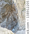 Mountain river flowing through a stone crevice, North Ossetia, Russia, bright summer day. Clear water rushing between narrow rocky walls under sunlight 138912205