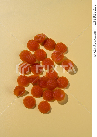 Jelly gummies close-up, fruit vitamins raspberry shaped, food supplements.Orange vitamins candies Jelly gummies close-up, fruit vitamins raspberry shaped, food supplements.Orange vitamins candies 138912219
