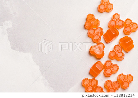 Jelly gummies fruit vitamins on bright background, food supplements.Orange vitamins candies Jelly gummies fruit vitamins on bright background, food supplements.Orange vitamins candies 138912234