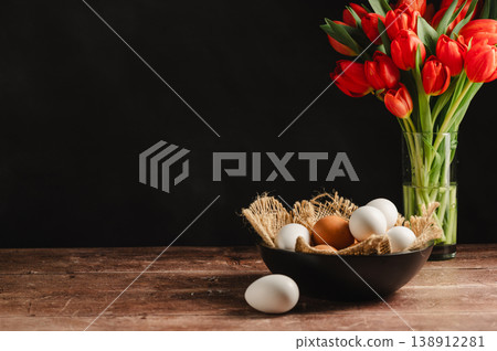 Easter eggs and red tulips bouquet. Festive Spring background for greeting cards. 138912281